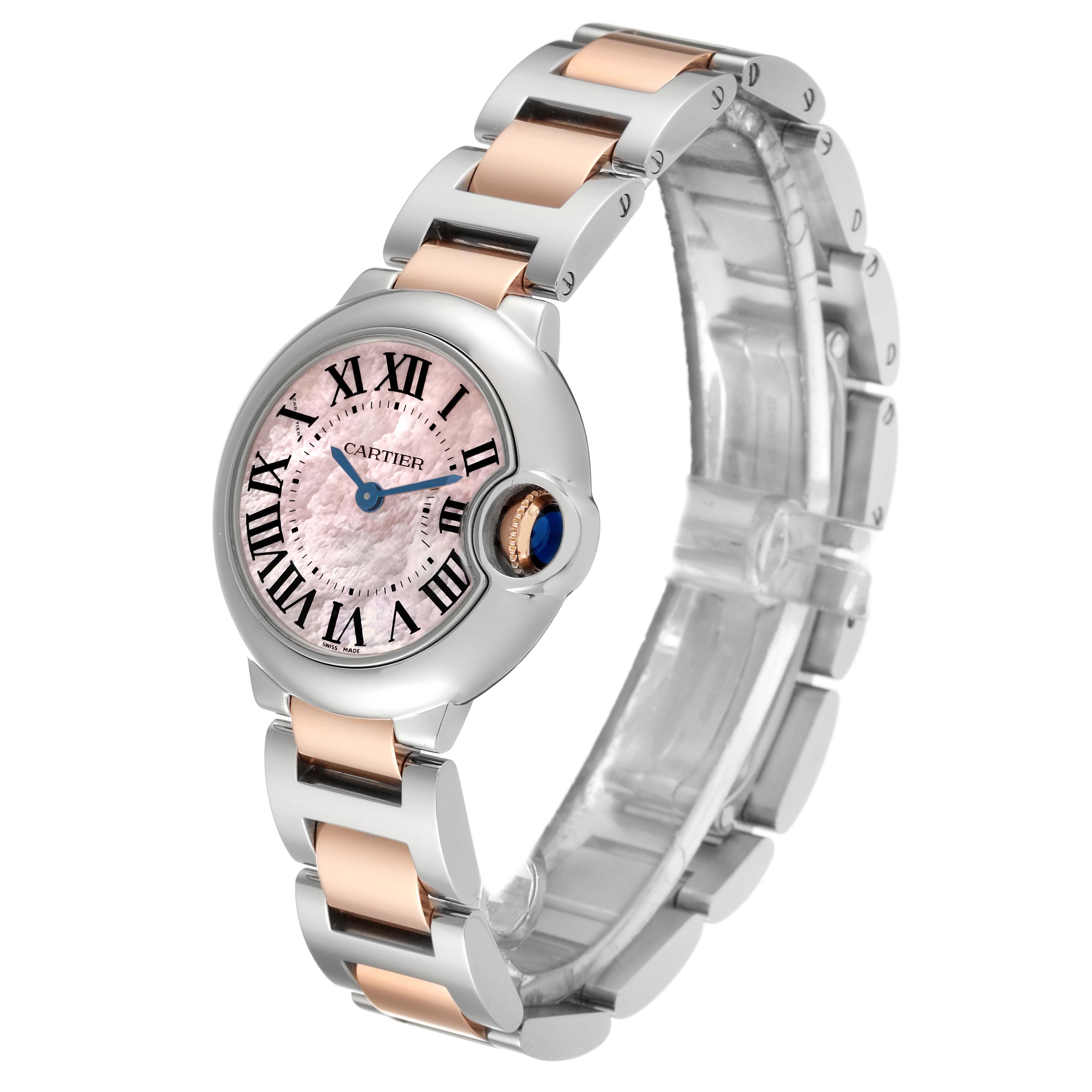 The image shows a Cartier Ballon Bleu W6920034 Women's Steel and Gold (two tone) Mother of Pearl Dial W6920034 Women's Steel and Gold (two tone) Mother of Pearl Dial watch with a pink dial and metal and rose gold bracelet, viewed from an angled perspective.
