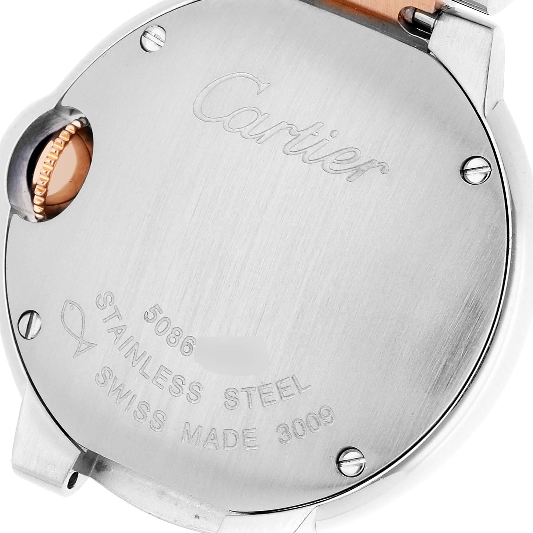 The image shows the back case and crown of the Ballon Bleu model by Cartier, featuring engraved details and markings.