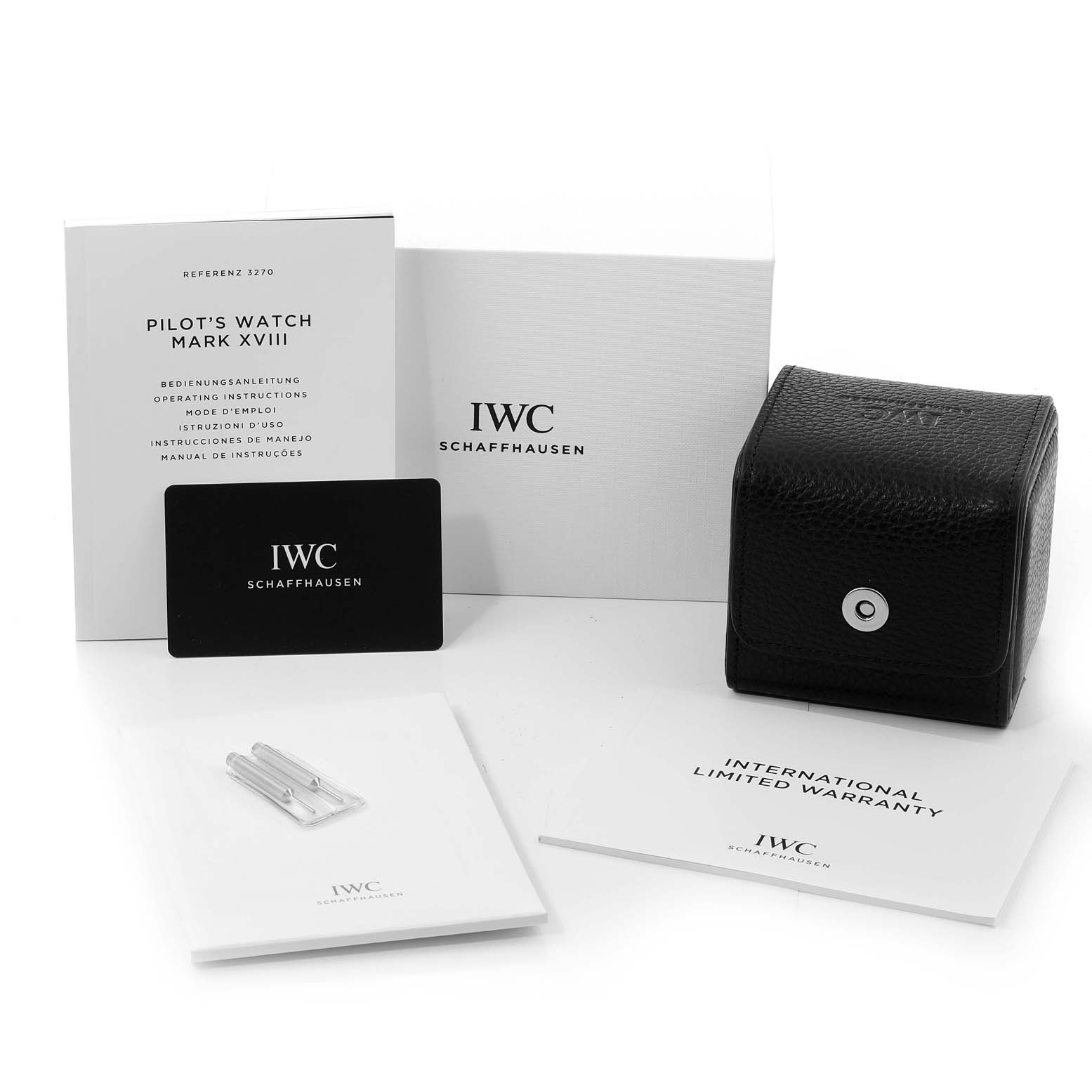 The image shows the IWC Pilot IW327015 Men's Stainless Steel Black Dial IW327015 Men's Stainless Steel Black Dial's Watch Mark XVIII packaging, including a leather case, manuals, warranty card, and watch tools.