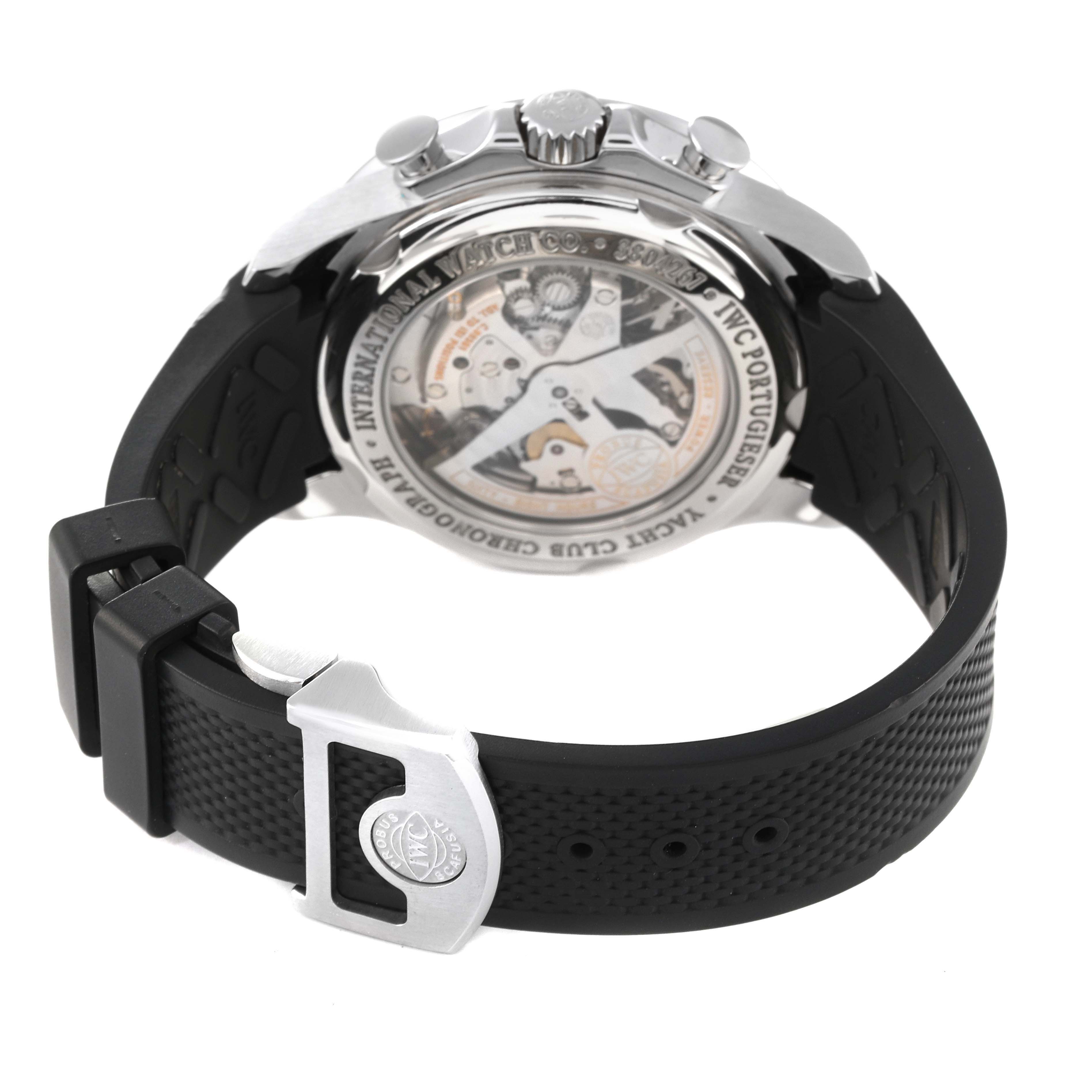 The image shows the back of the IWC Portuguese IW390210 Men's Stainless Steel Black Dial IW390210 Men's Stainless Steel Black Dial model watch, highlighting its movement, crown, and black rubber strap with a branded clasp.