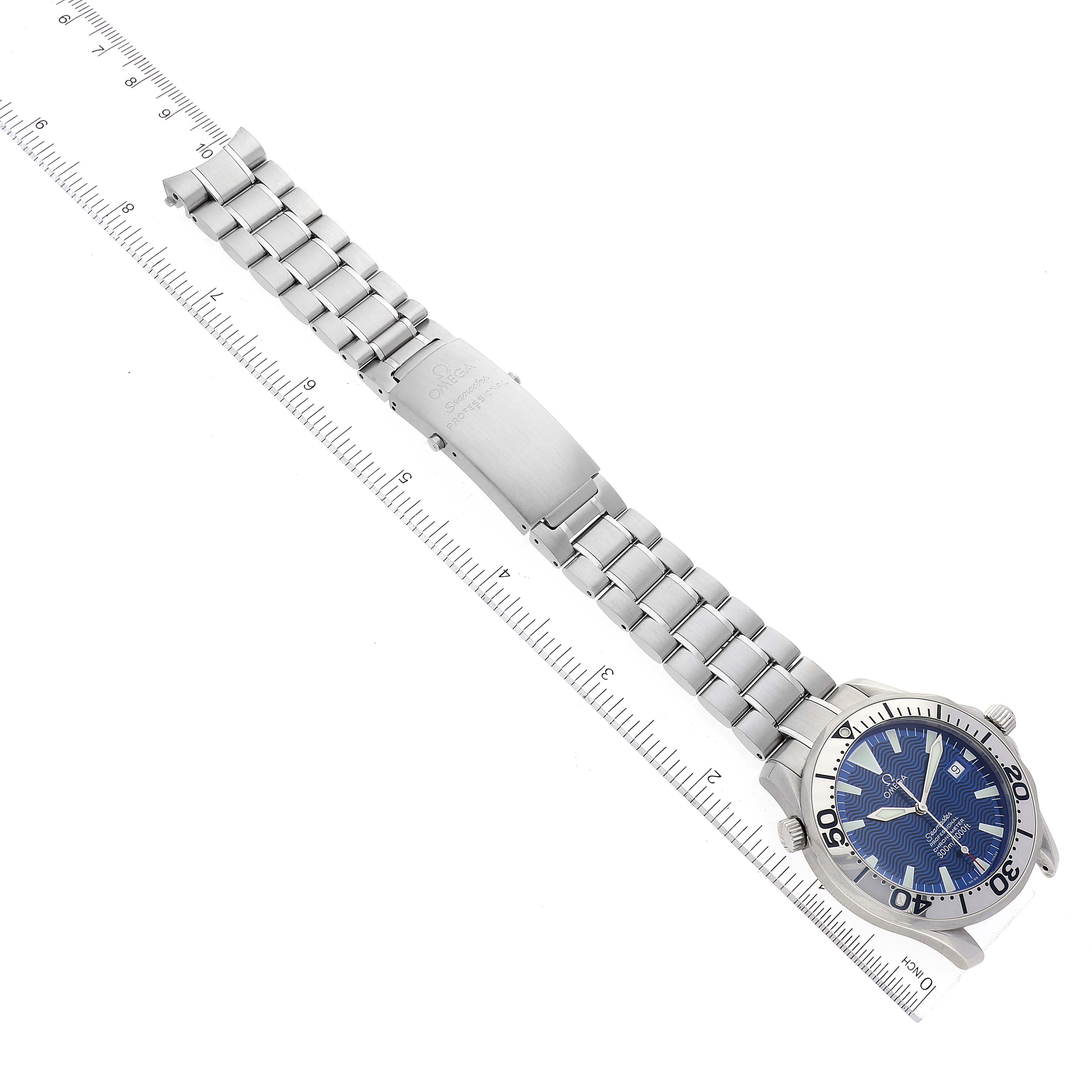The image shows the Omega Seamaster 2255.80.00 Men's Stainless Steel Blue Dial 2255.80.00 Men's Stainless Steel Blue Dial watch flat against a ruler, displaying its full bracelet and face from a top-down angle.
