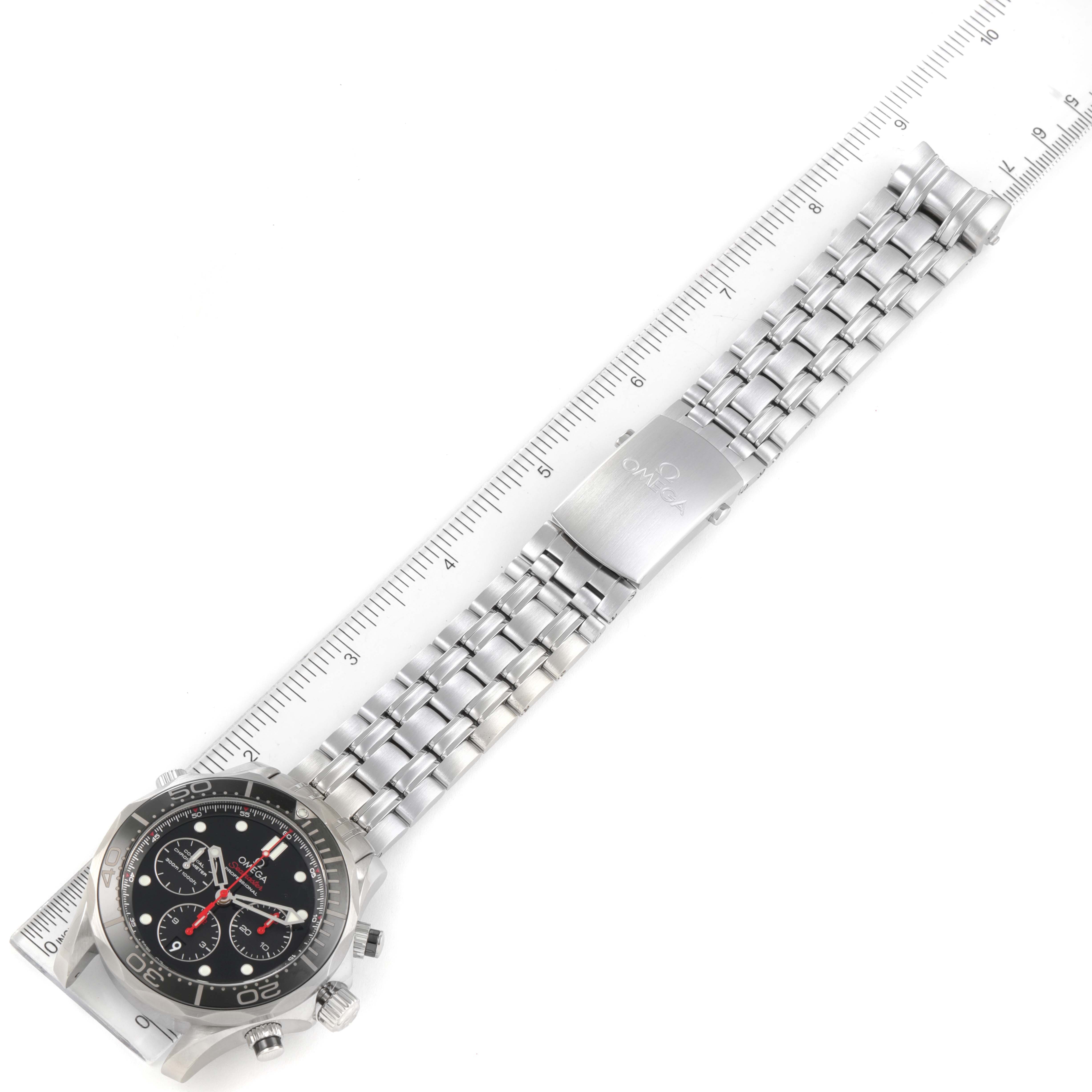 The Omega Seamaster 212.30.44.50.01.001 Men's Stainless Steel Black Dial 212.30.44.50.01.001 Men's Stainless Steel Black Dial watch is shown flat with the entire stainless steel bracelet extended beside a ruler.