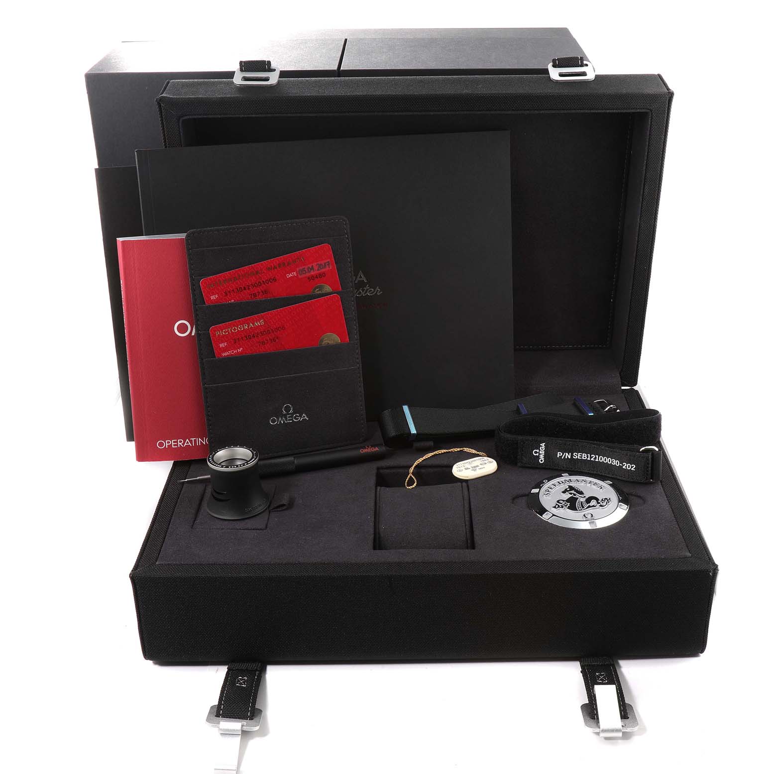 This image shows a boxed set of Omega Speedmaster 311.30.42.30.01.006 Men's Stainless Steel Black Dial 311.30.42.30.01.006 Men's Stainless Steel Black Dial watch accessories, including manuals, cards, straps, and a magnifying glass.