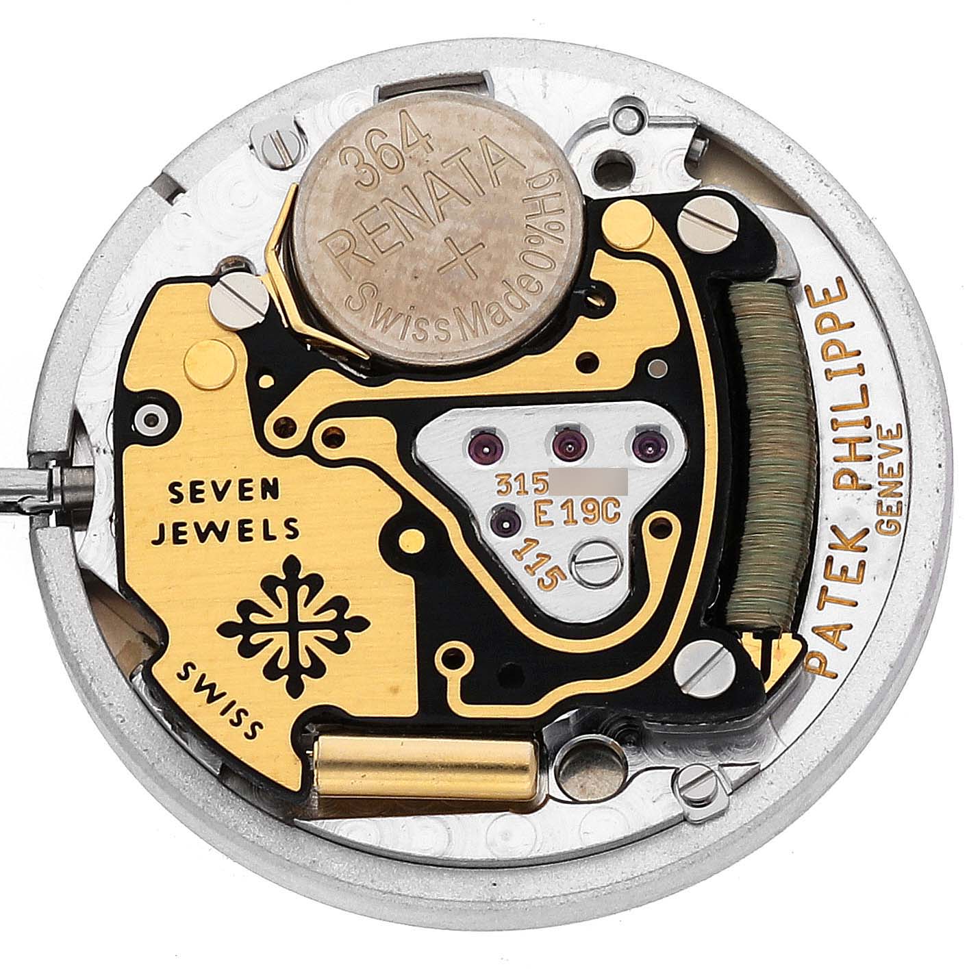 The image shows the internal movement mechanism of a Patek Philippe Nautilus 4700/051 Women's Yellow Gold White Dial 4700/051 Women's Yellow Gold White Dial watch, including the battery, coils, and jewels.