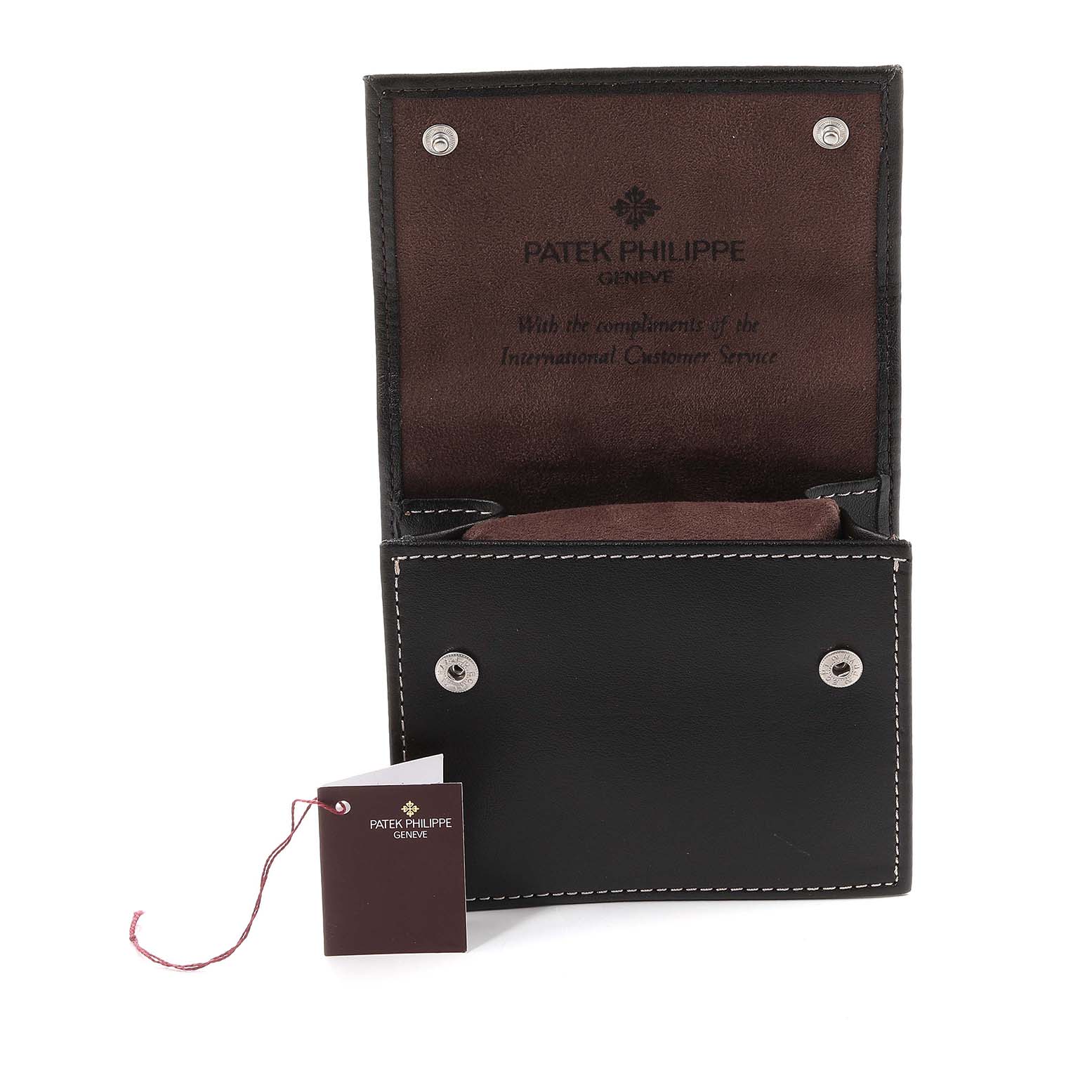 The image shows an open Patek Philippe Nautilus 4700/051 Women's Yellow Gold White Dial 4700/051 Women's Yellow Gold White Dial watch case and a hangtag from a straight-on angle.