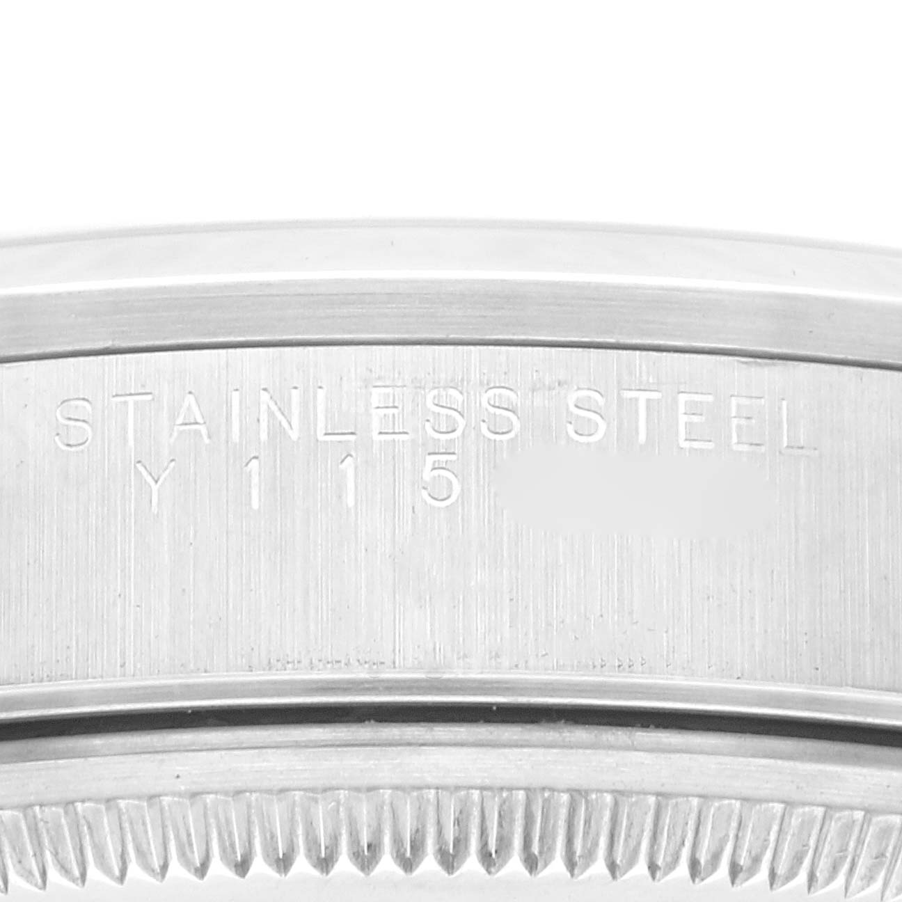 This image shows a close-up of the caseback edge of a Rolex Air-King 14000 Men's Stainless Steel Blue Dial 14000 Men's Stainless Steel Blue Dial watch, revealing the engraved "STAINLESS STEEL" marking and model number.