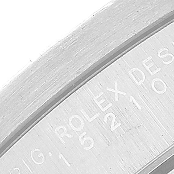 This image shows a close-up of the engraved text on the interior rim of a Rolex Date 15210 Men
s Stainless Steel Blue Dial 15210 Men
s Stainless Steel Blue Dial model watch.