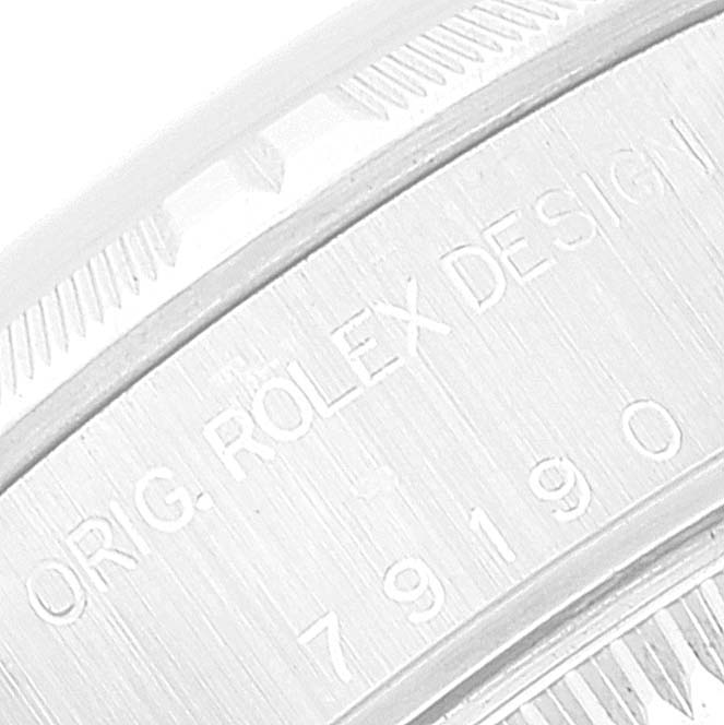 This is a close-up of the case side of a Rolex Date 79190 Women
s Stainless Steel Pink Dial 79190 Women
s Stainless Steel Pink Dial model, showing the engraving and fluted bezel.