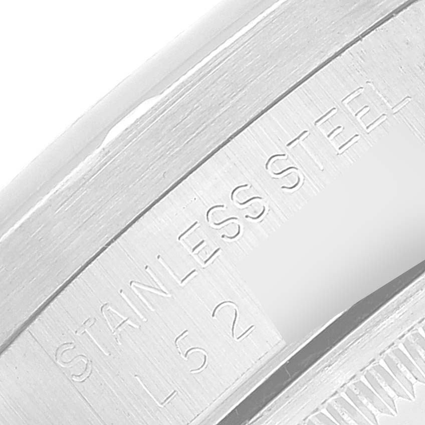 The image shows an engraved part of the Rolex Date 15210 Men
s Stainless Steel Silver Dial 15210 Men
s Stainless Steel Silver Dial model, highlighting "STAINLESS STEEL L 52."