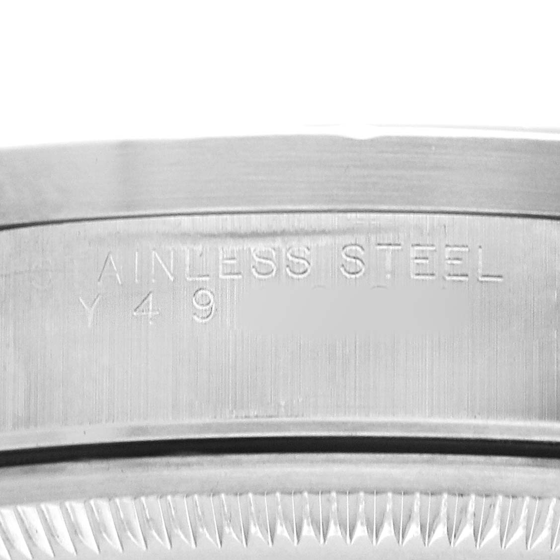 The image shows a close-up of the side engraving on a Rolex Date 15210 Men's Stainless Steel Pink Dial model, focusing on the stainless steel part.