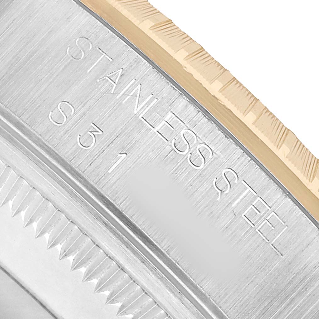 The image shows a close-up of the Rolex Date 15223 Men's Steel and Gold (two tone) Silver Dial model's bezel and case, highlighting the stainless steel material marking.