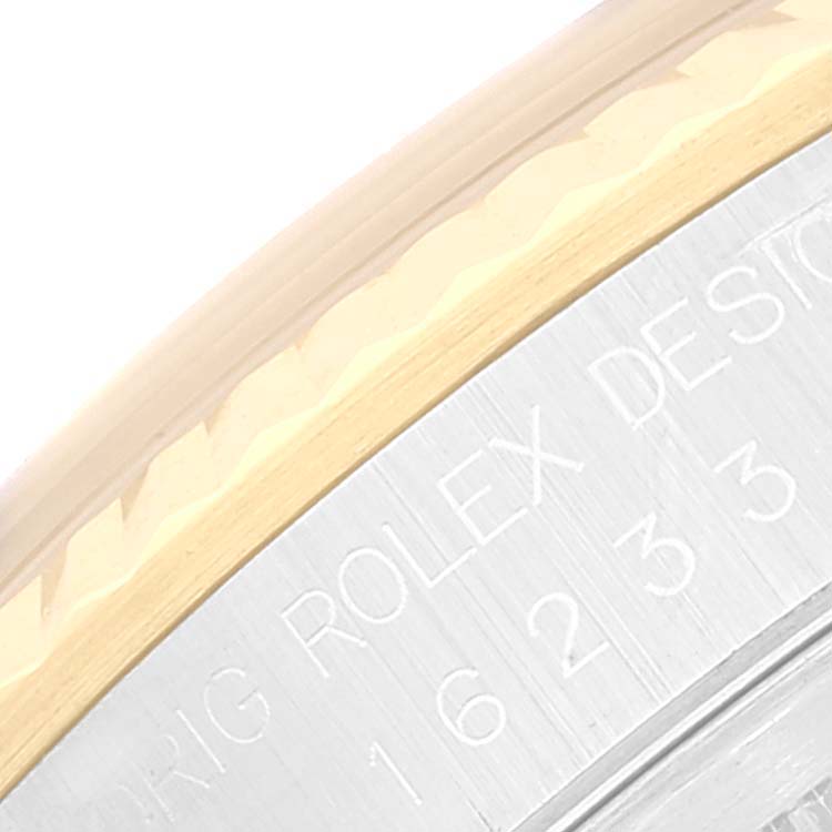 This image shows a close-up angle of the side and engraved part of a Rolex Datejust 16233 Men's Steel and Gold (two tone) Blue Dial 16233 Men's Steel and Gold (two tone) Blue Dial watch.