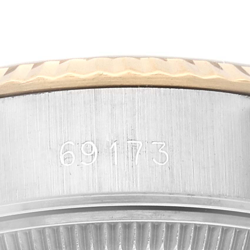 This close-up image shows the side of the bezel and case edge of a Rolex Datejust 69173 Women's Steel and Gold (two tone) Champagne Dial 69173 Women's Steel and Gold (two tone) Champagne Dial watch, displaying the model number engraved.