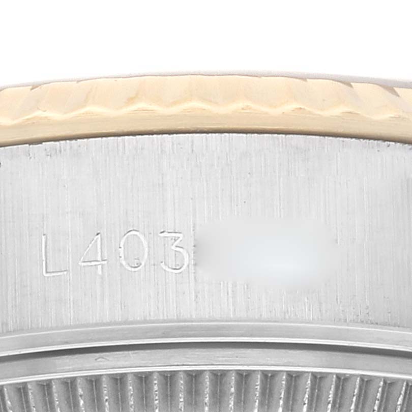 The image shows a close-up view of the side engraving and bezel of a Rolex Datejust 69173 Women's Steel and Gold (two tone) Champagne Dial 69173 Women's Steel and Gold (two tone) Champagne Dial watch.