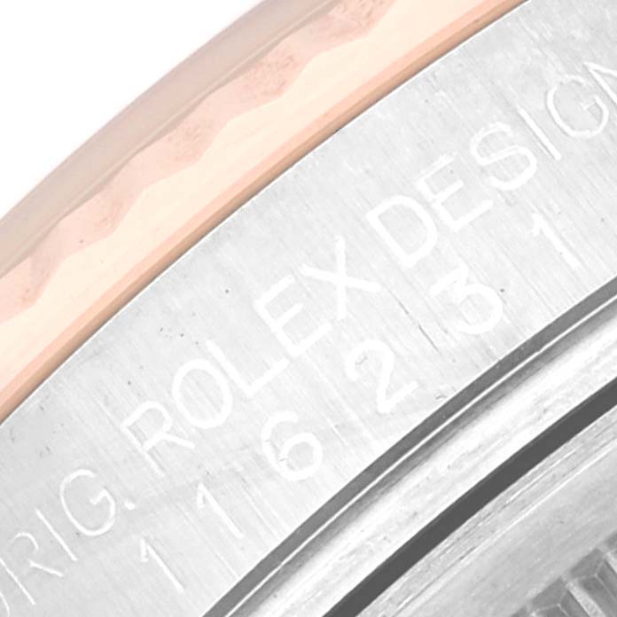 This close-up image shows the engraved side of the bezel of a Rolex Datejust 116231G Men's Steel and Gold (two tone) Pink Dial 116231G Men's Steel and Gold (two tone) Pink Dial watch.