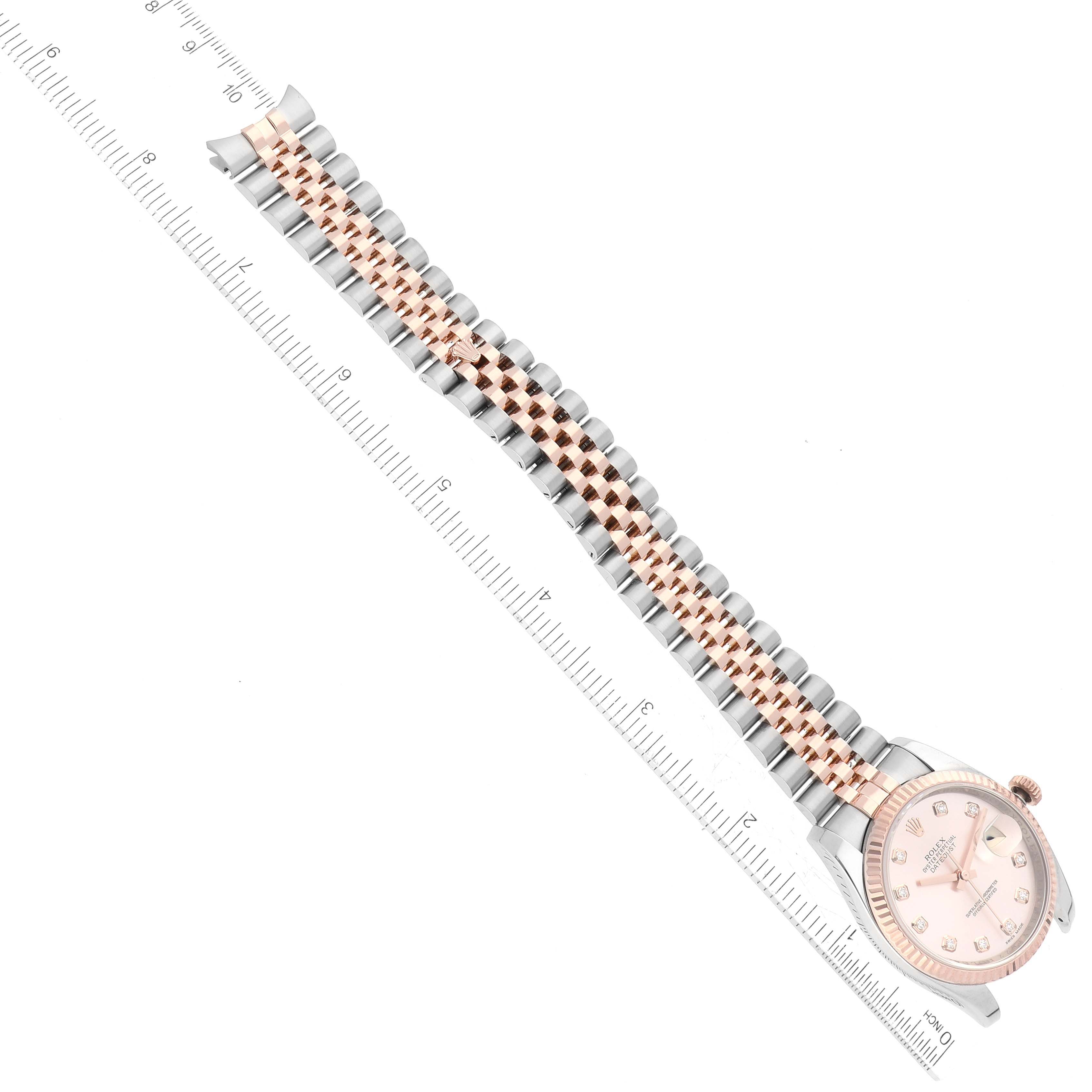 The image shows a top-down view of a Rolex Datejust 116231G Men's Steel and Gold (two tone) Pink Dial 116231G Men's Steel and Gold (two tone) Pink Dial watch, highlighting the dial, bezel, and bracelet with a ruler for scale.