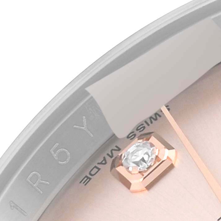 This close-up angle shows a portion of the dial and a diamond marker of a Rolex Datejust 116231G Men's Steel and Gold (two tone) Pink Dial 116231G Men's Steel and Gold (two tone) Pink Dial watch.