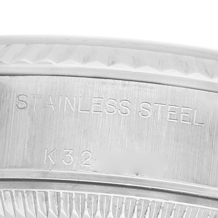 The image shows a close-up of the side view of a Rolex Datejust 79174 Women's Stainless Steel White Dial, highlighting the engravings on the stainless steel case.