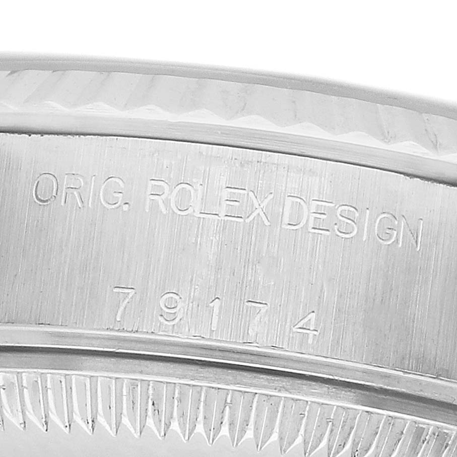 The image shows the engravings on the side of a Rolex Datejust 79174 Women's Stainless Steel White Dial's case, including "ORIG. ROLEX DESIGN" and a reference number.