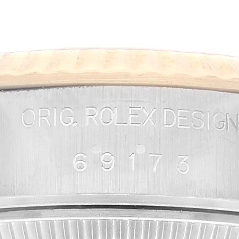 This image shows a close-up of the model number and “ORIG. ROLEX DESIGN” engraving on the case side of a Rolex Datejust 69173 Women's Steel and Gold (two tone) Champagne Dial 69173 Women's Steel and Gold (two tone) Champagne Dial watch.