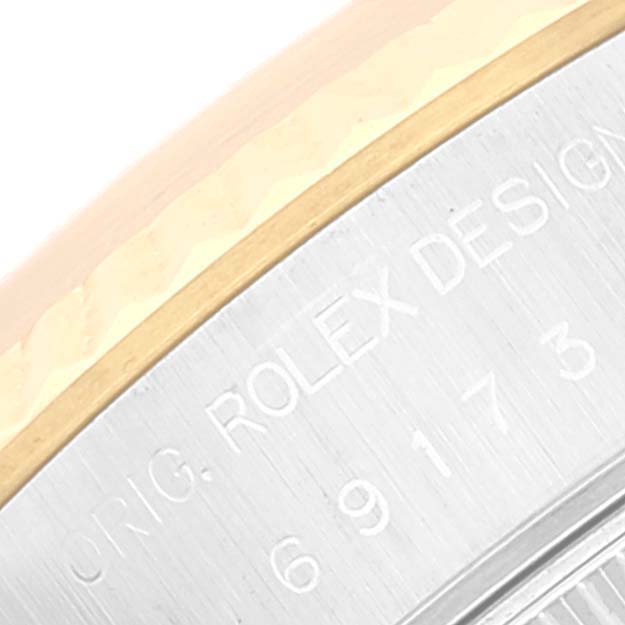 The image shows a close-up of the outer edge and engraving of a Rolex Datejust 69173 Women's Steel and Gold (two tone) Champagne Dial 69173 Women's Steel and Gold (two tone) Champagne Dial watch case.
