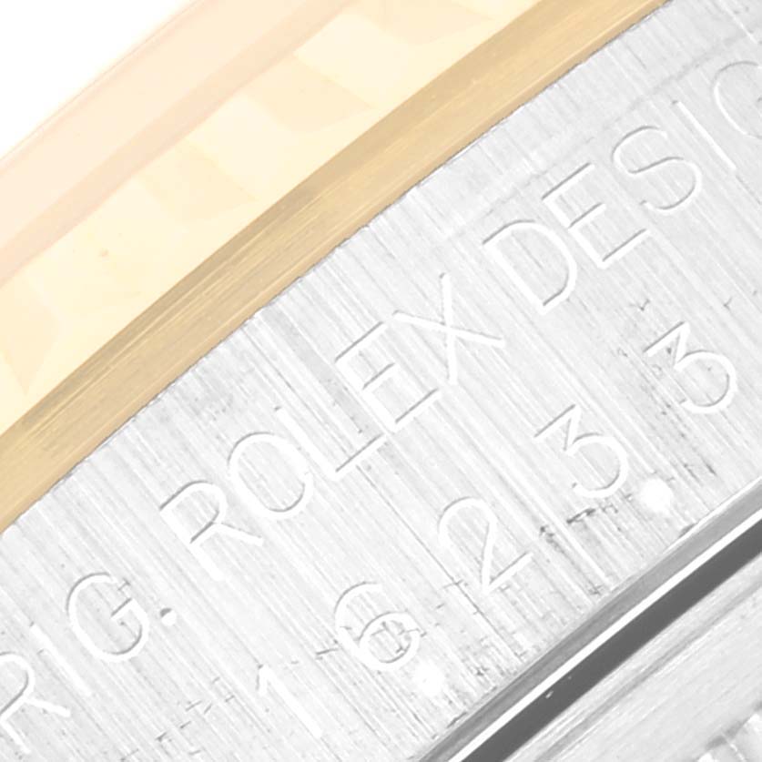 This image shows a close-up of the engraved writing on the outer rim of a Rolex Datejust 16233 Men's Steel and Gold (two tone) Champagne Dial 16233 Men's Steel and Gold (two tone) Champagne Dial model watch.