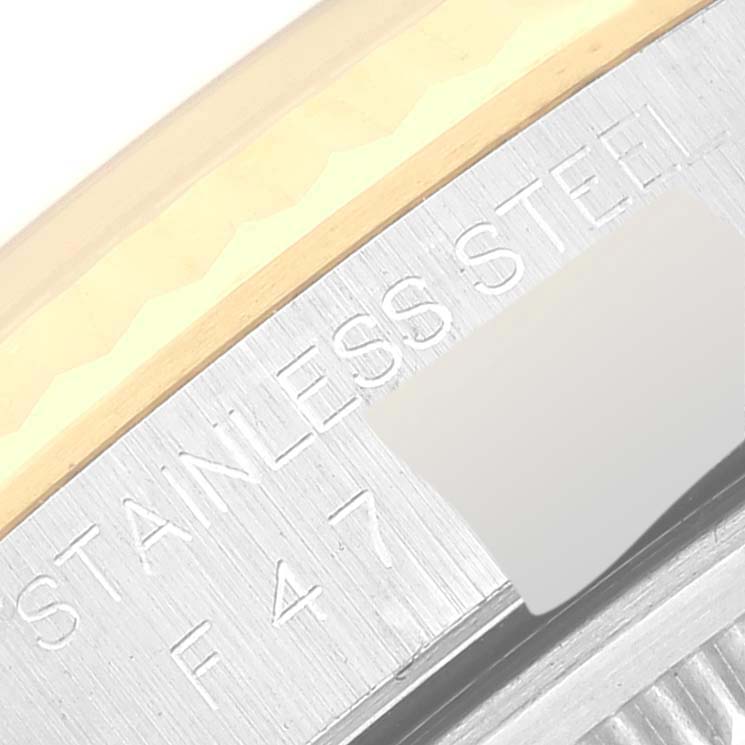The image shows a close-up of the casing of a Rolex Datejust 16233 Men's Steel and Gold (two tone) Beige Dial 16233 Men's Steel and Gold (two tone) Beige Dial, highlighting the "STAINLESS STEEL" engraving.