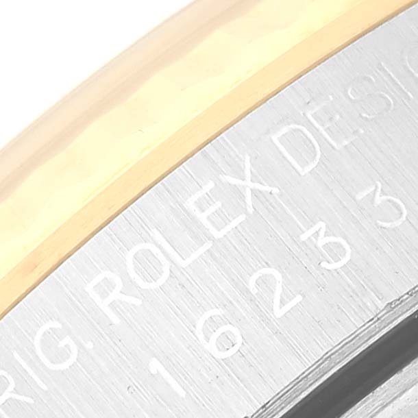 This image shows a close-up of the engravings on the side of a Rolex Datejust 16233 Men's Steel and Gold (two tone) Beige Dial 16233 Men's Steel and Gold (two tone) Beige Dial watch bezel.
