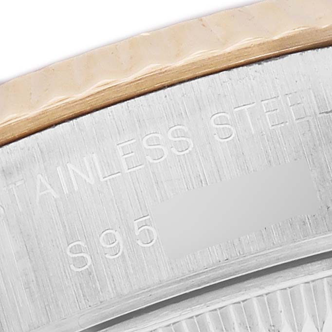 The image shows a close-up of the side of a Rolex Datejust 69173 Women's Steel and Gold (two tone) Silver Dial watch, highlighting "STAINLESS STEEL" text on its case.