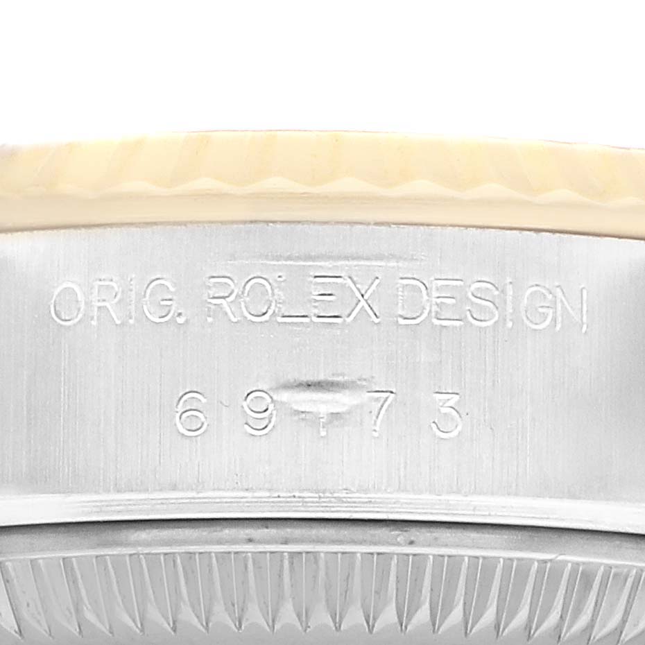 The image shows the side engraving on a Rolex Datejust 69173 Women's Stainless Steel White Dial case, displaying the model number and "ORIG. ROLEX DESIGN."