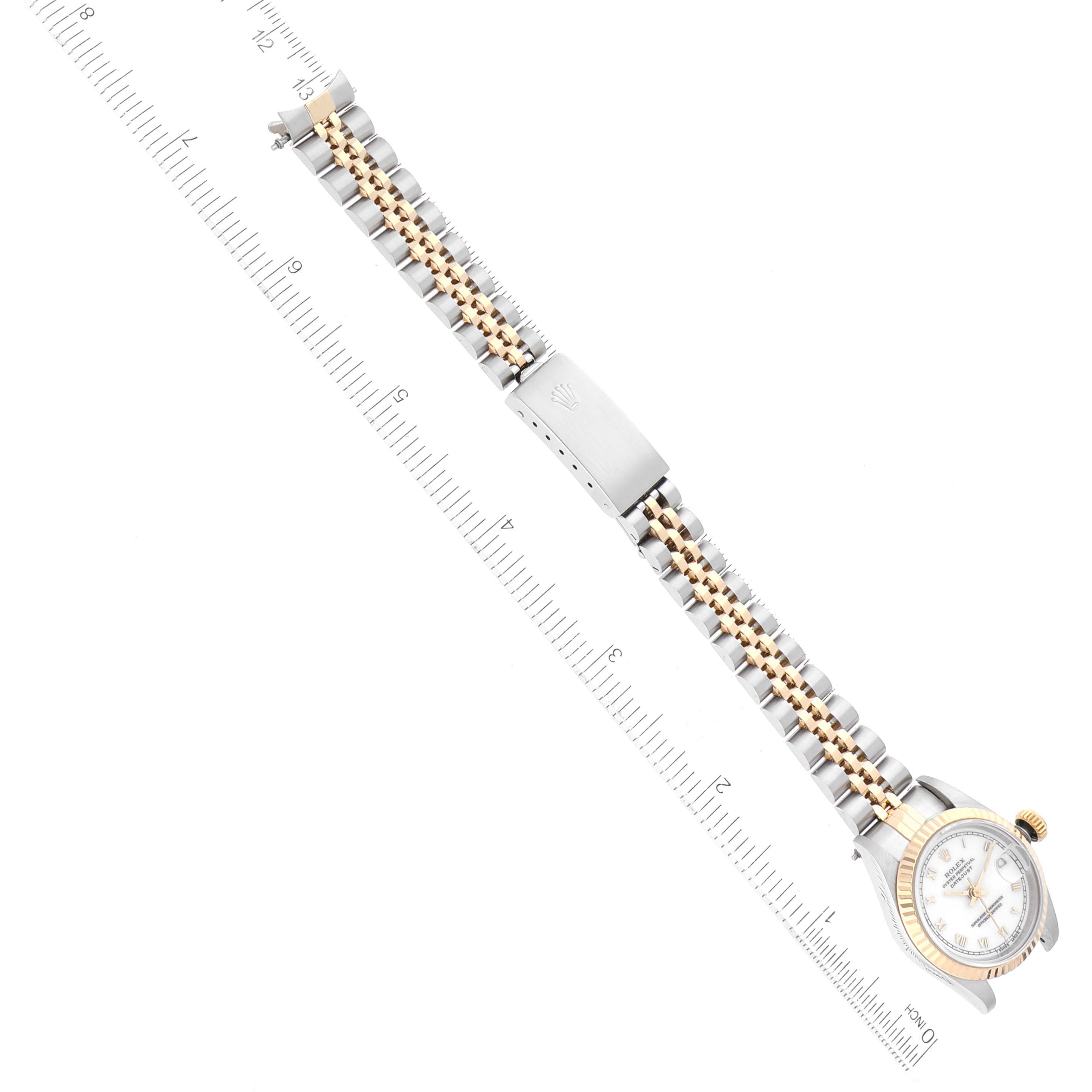 The image shows a Rolex Datejust 69173 Women's Steel and Gold (two tone) White Dial 69173 Women's Steel and Gold (two tone) White Dial watch laying flat with a metal bracelet and clasp, accompanied by a ruler for scale.