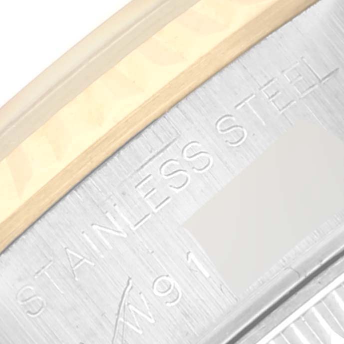 This image shows a close-up of the Datejust watch by Rolex, focusing on the stainless steel back with engraved text.