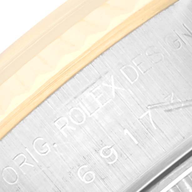 The image shows a close-up of the underside of a Rolex Datejust 69173 Women's Steel and Gold (two tone) White Dial 69173 Women's Steel and Gold (two tone) White Dial watch, highlighting the engraving on the metal band.