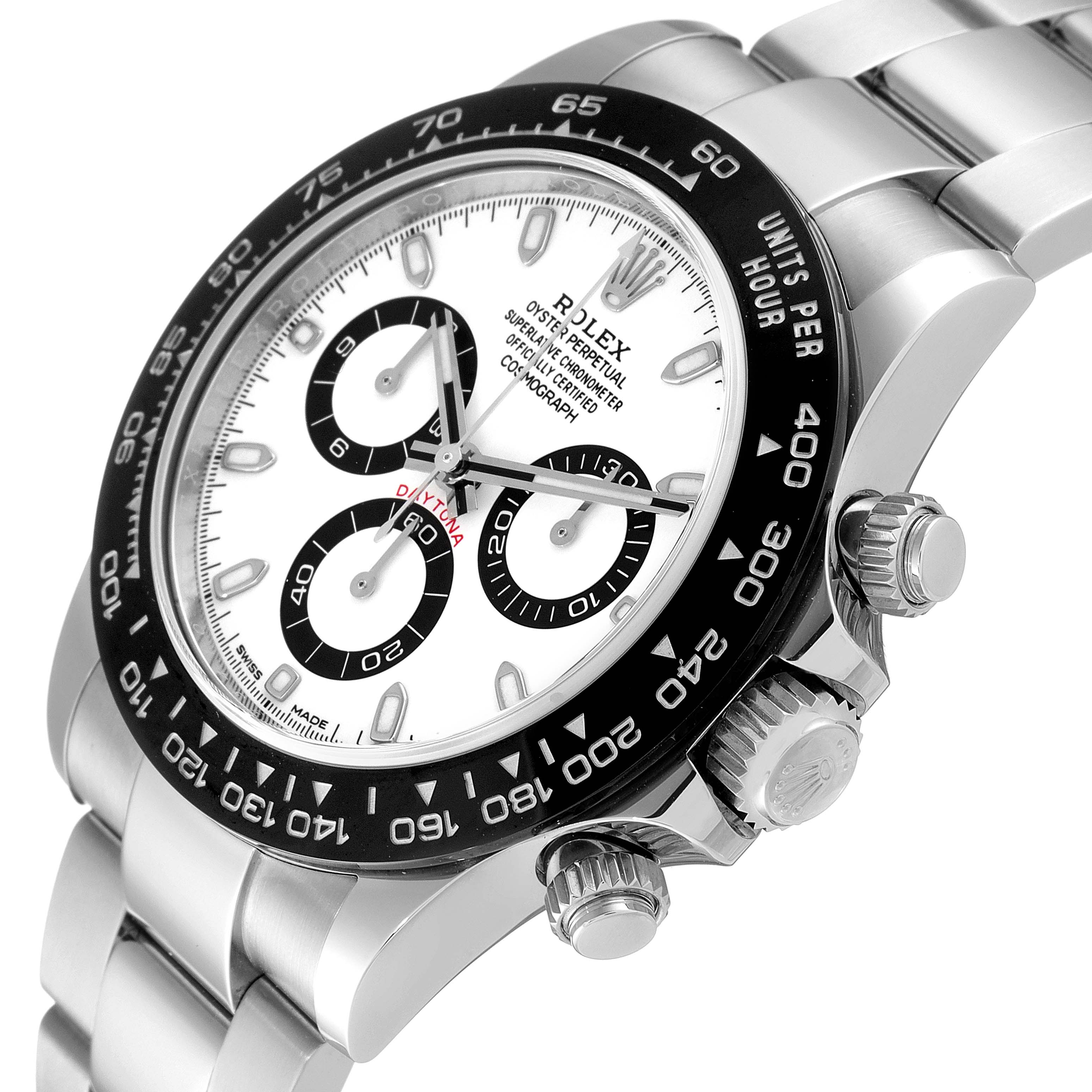 The image shows a close-up angle of the Rolex Daytona 116500 Men's Stainless Steel White Dial 116500 Men's Stainless Steel White Dial watch highlighting the bezel, dial, and crown.