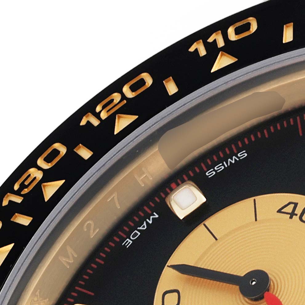 This close-up image of a Rolex Daytona 116518LN Men's Yellow Gold Black Dial 116518LN Men's Yellow Gold Black Dial watch showcases the bezel and part of the dial with distinct markers.