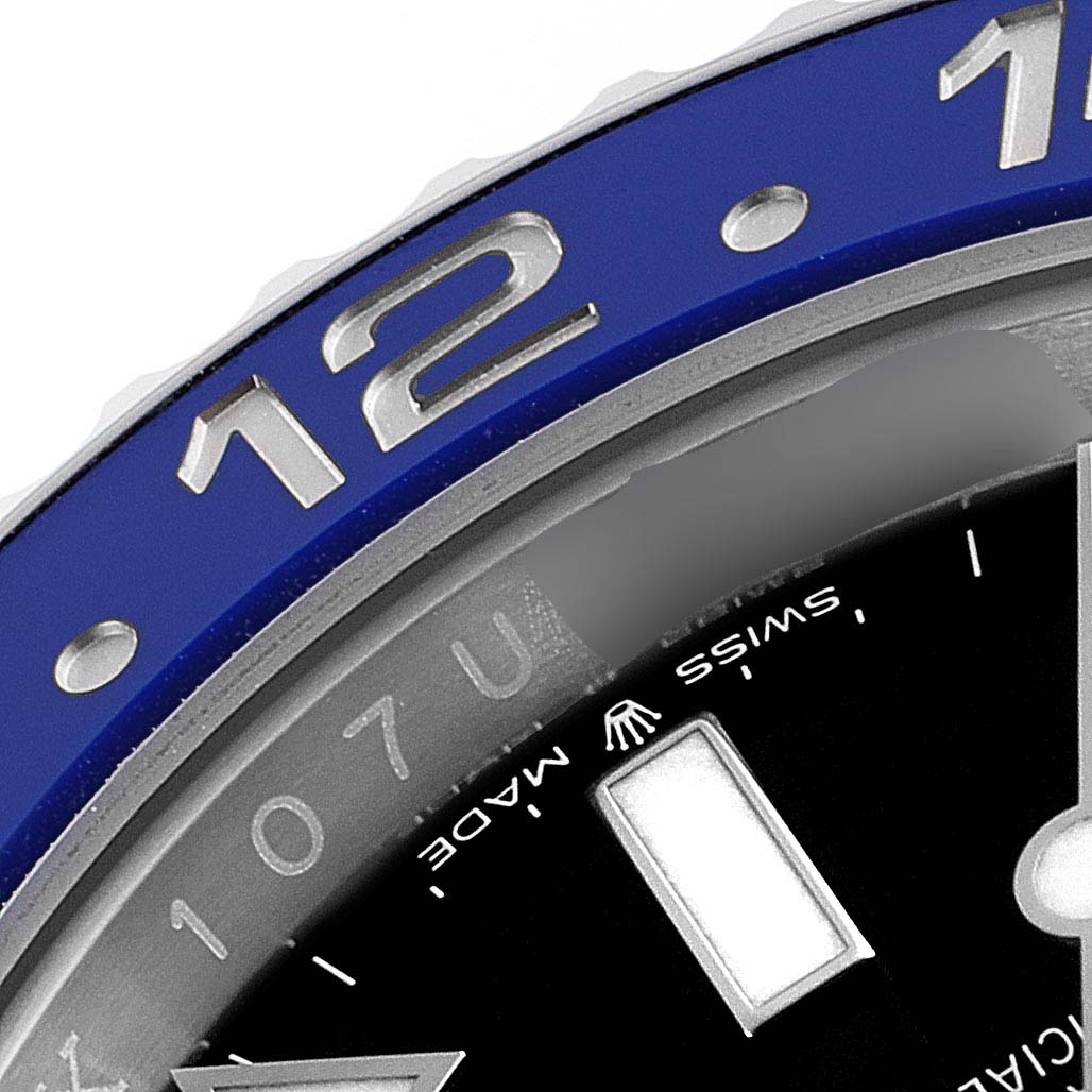 The close-up image of the Rolex GMT-Master 126710 Men
s Stainless Steel Black Dial 126710 Men
s Stainless Steel Black Dial shows part of the watch face and the bezel, including the number 12 marker.