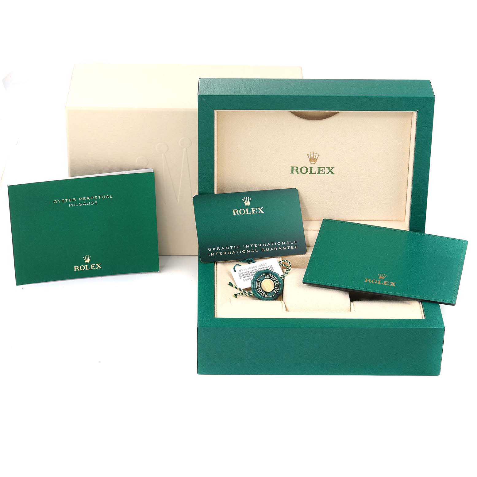 The image shows the packaging, warranty cards, and manual for a Rolex Oyster Perpetual Milgauss watch.