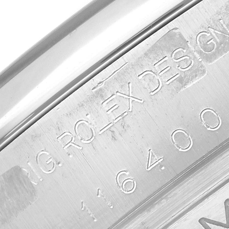 This image shows an engraved part of the inner bezel of a Rolex Milgauss 116400 Men's Stainless Steel White Dial 116400 Men's Stainless Steel White Dial watch, displaying the brand name and model number.