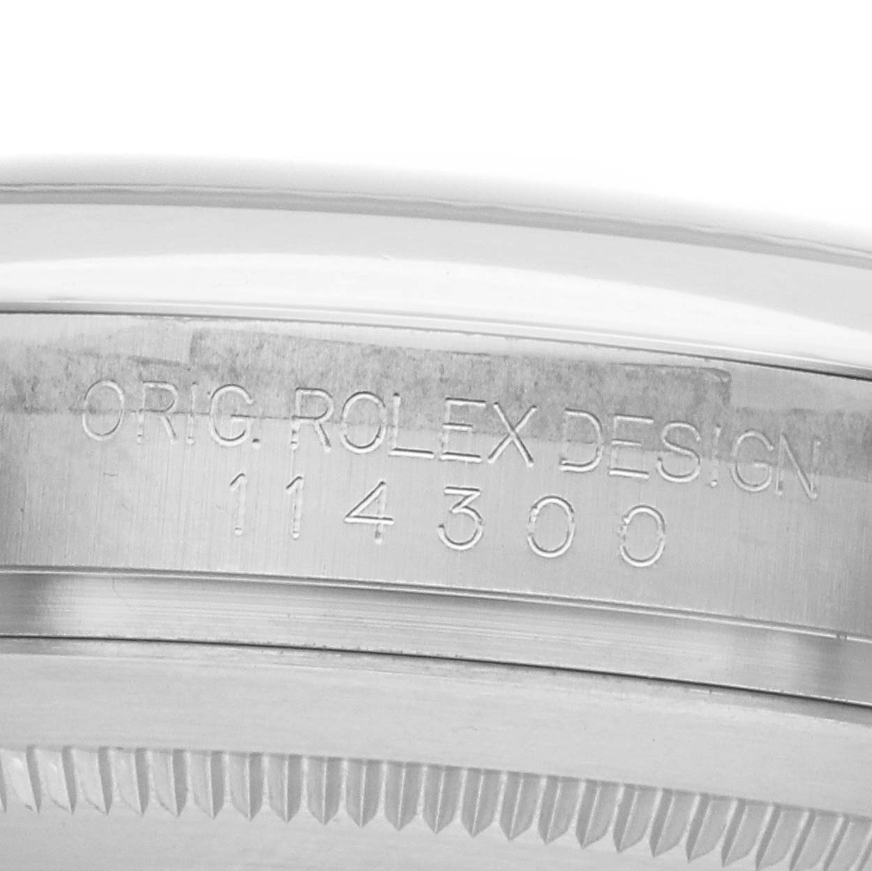 The image shows the side engraving on the case of a Rolex Oyster Perpetual 114300 Men's Stainless Steel Grey Dial watch, displaying its model number.