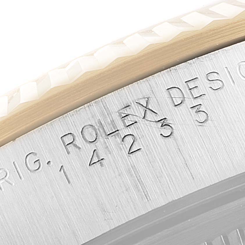 The image shows a close-up of the engraved bezel and case of a Rolex Oyster Perpetual 14233 Men's Steel and Gold (two tone) Black Dial 14233 Men's Steel and Gold (two tone) Black Dial watch.