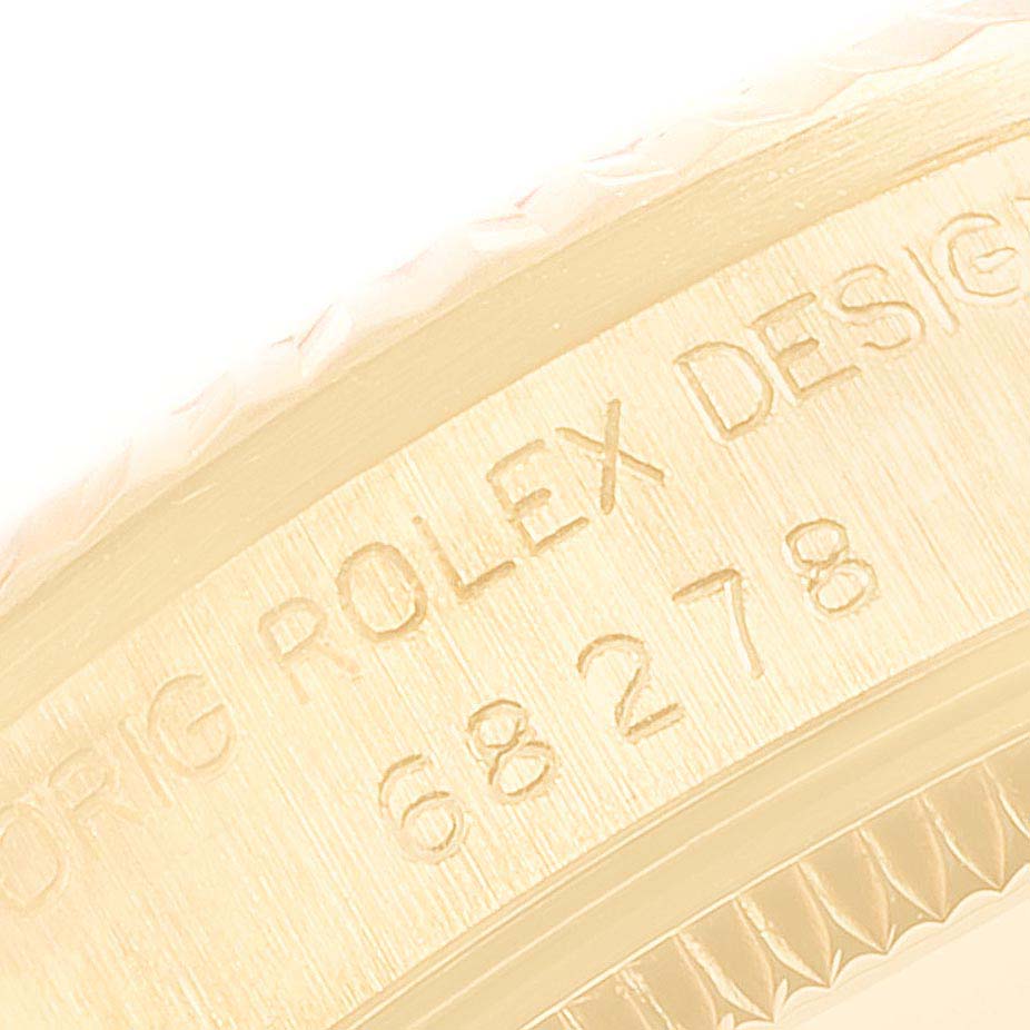 This is a close-up of the engraved side of the bezel of a Rolex President 68278 Women's Yellow Gold Champagne Dial 68278 Women's Yellow Gold Champagne Dial model watch.