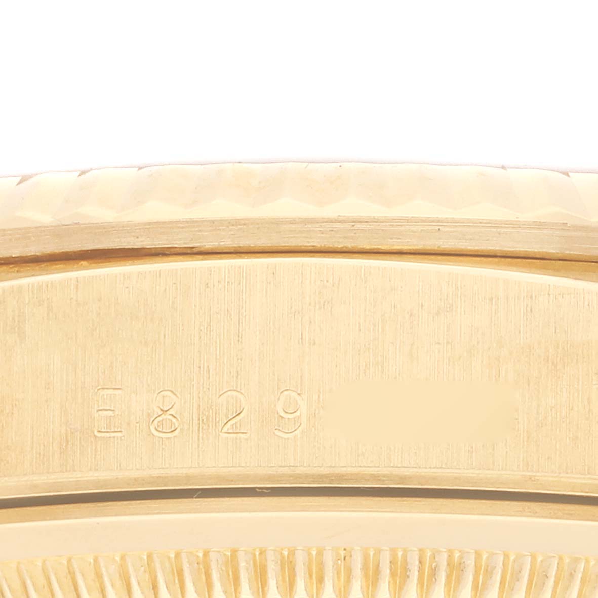 This image shows a close-up angle of the serial number engraved on the case of a Rolex President 18238 Men's Yellow Gold Champagne Dial 18238 Men's Yellow Gold Champagne Dial model watch.