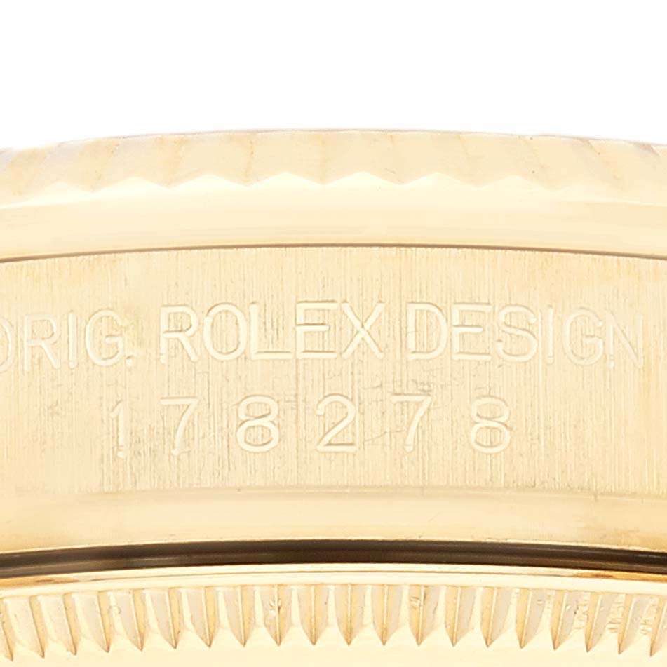 This image shows a close-up of the side of a Rolex President 178278 Women's Yellow Gold Champagne Dial 178278 Women's Yellow Gold Champagne Dial model watch, focusing on its case with its model number engraved.