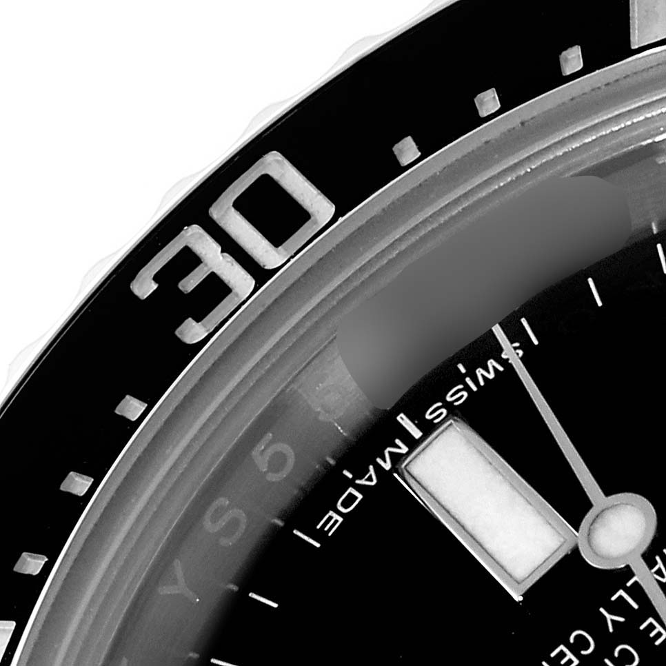 This image shows a close-up of the bezel and part of the dial of a Rolex Sea-Dweller 116600 Men
s Stainless Steel Black Dial 116600 Men
s Stainless Steel Black Dial watch, highlighting the 30-minute mark.