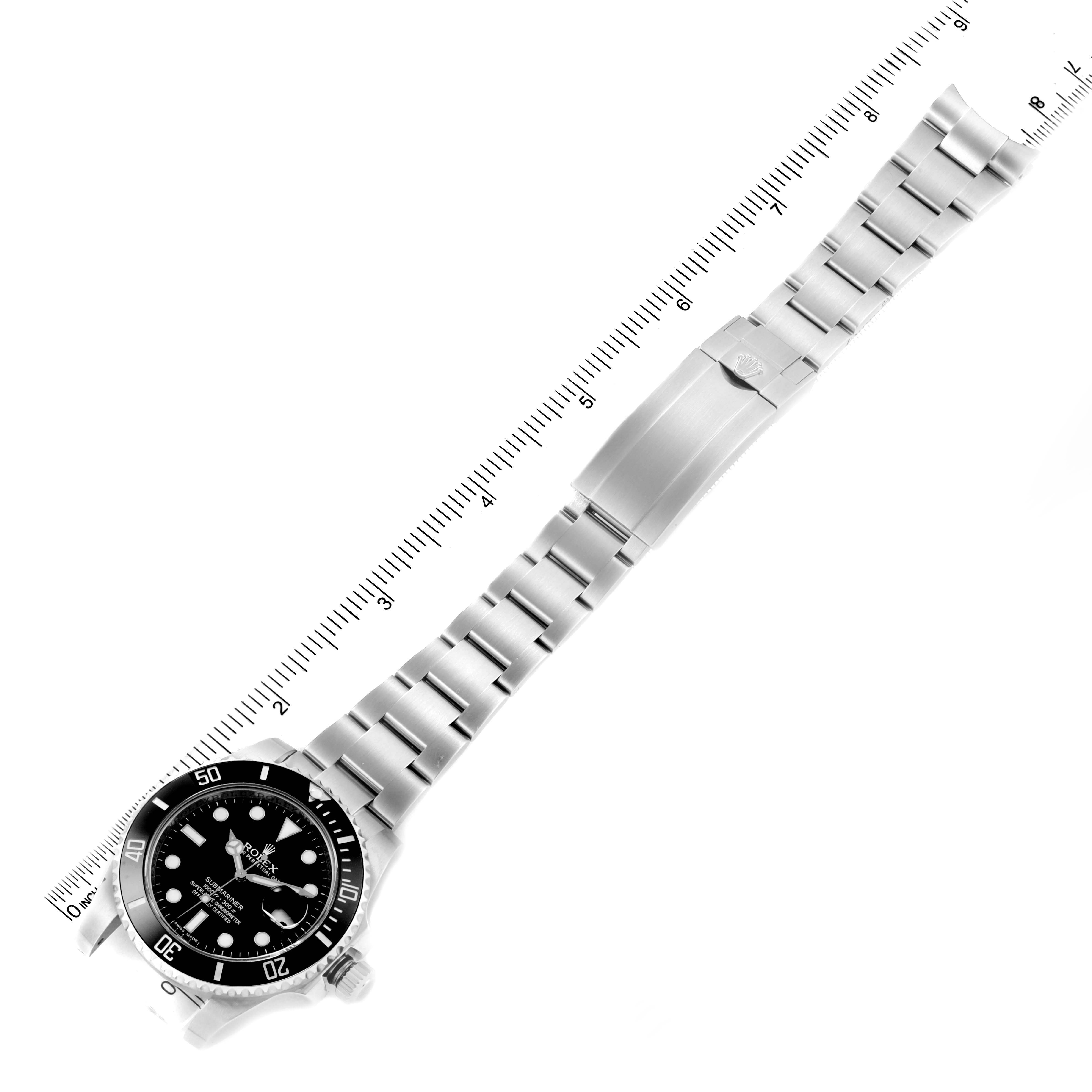 This image shows a top view of a Rolex Submariner 116610 Men's Stainless Steel Black Dial 116610 Men's Stainless Steel Black Dial watch, including the face, bezel, and bracelet with a ruler for scale.