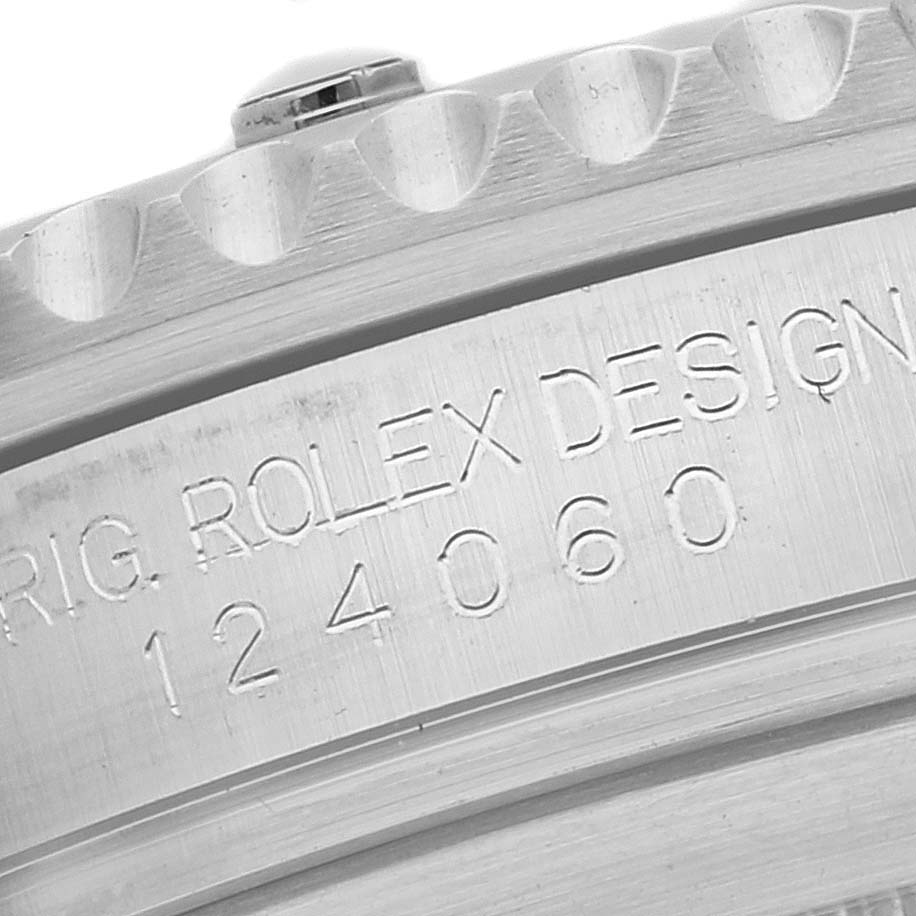 The image shows an angled close-up of the engraved reference number and bezel of a Rolex Submariner 124060 Men
s Stainless Steel Black Dial 124060 Men
s Stainless Steel Black Dial watch.