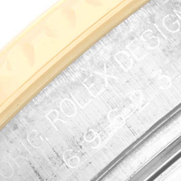 This close-up image shows the edge of the bezel and part of the engraved inner rim of a Rolex Yacht-Master 69623 Women's Steel and Gold (two tone) Grey Dial 69623 Women's Steel and Gold (two tone) Grey Dial watch.