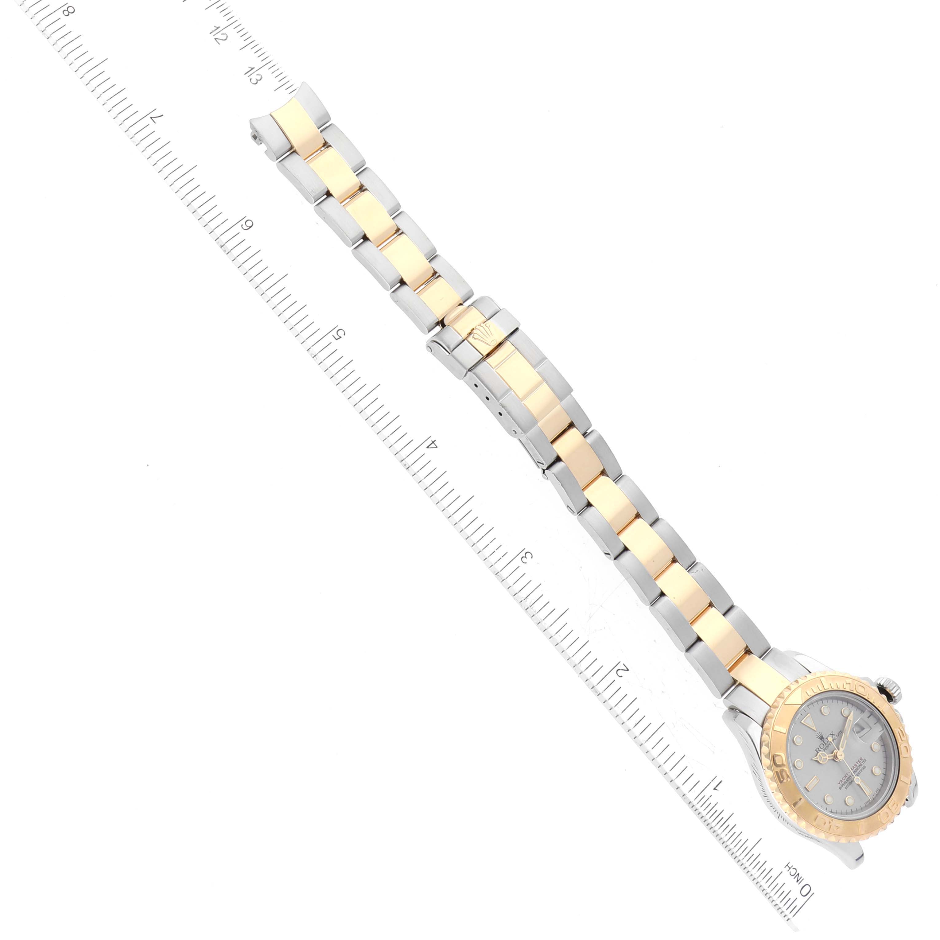 The image shows a Rolex Yacht-Master 69623 Women's Steel and Gold (two tone) Grey Dial 69623 Women's Steel and Gold (two tone) Grey Dial watch laid flat with the dial and bracelet clearly visible, alongside a ruler for scale.