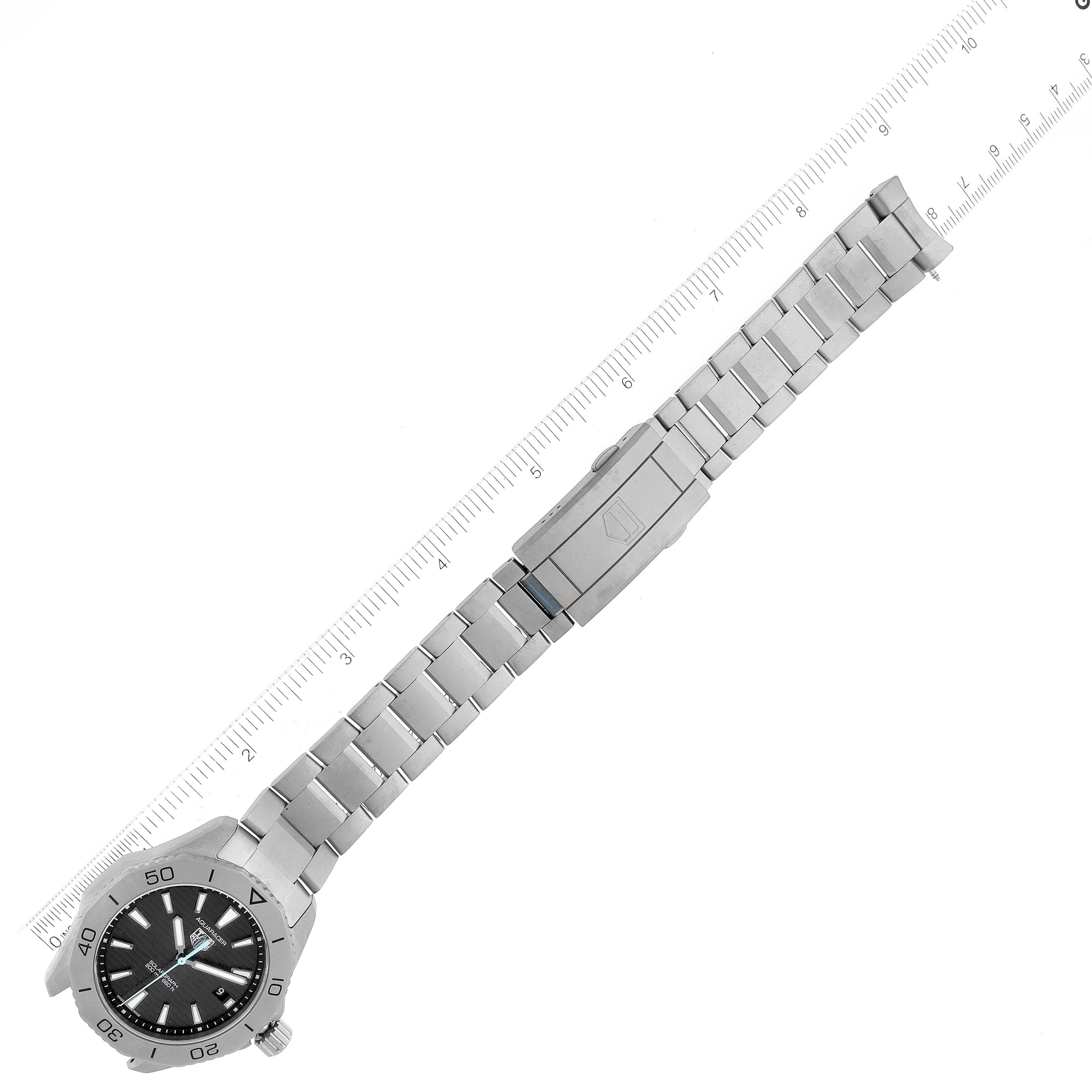 The image shows a Tag Heuer Aquaracer WBP1180.BF0000 Men's Titanium Black Dial WBP1180.BF0000 Men's Titanium Black Dial watch with the bracelet fully extended and a ruler next to it, showcasing its length and clasp.