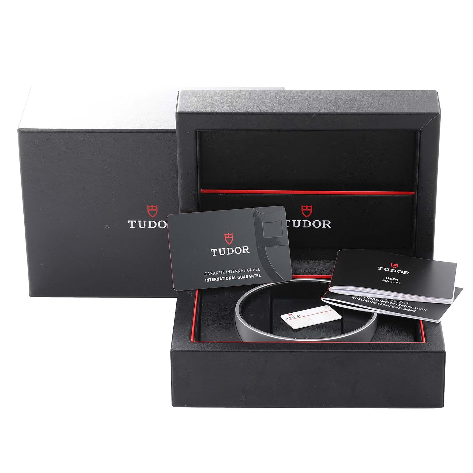 The image shows the packaging, guarantee card, manual, and accessories of the Tudor Heritage Chrono M79360N-0002 Men's Stainless Steel Silver Dial M79360N-0002 Men's Stainless Steel Silver Dial watch from a front angle.